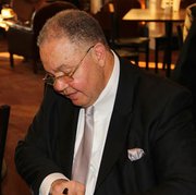 Baltimore Attorney A. Dwight Pettit signing his book. 