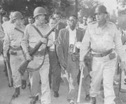 Newson being escorted away from a location near Central High School by Arkansas National Guard troops in 1957. 