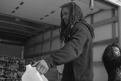 Deonte Ward and members of Black Wall Street Annapolis LLC distributed water to residents of Flint, Michigan at Triumph Church Flint Campus on March 6, 2016. 