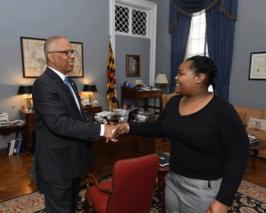 Lieutenant Governor Boyd K. Rutherford gives the 2019 Boys & Girls Clubs of America’s Maryland State “Youth of the Year”MiKayla Simms a congratulatory handshake.
