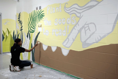 A camper works on the mural during the five-week camp.