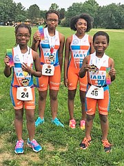 IABT junior athletes placed first, second and third in their respective age groups in a Youth Aquathon in  Columbia, Maryland in summer 2016. (Left to right) Halee (11), 3rd Place; Heaven (12), 2nd Place); Leiliani (13) is still learning to swim but came to support her teammates; and BJ (9), 1st Place..