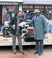Terrell Freeman, left, leads a libation ceremony. Darius A. Stanton, right, serves as the new Chair of the Annapolis Martin Luther King, Jr. Parade Committee. Stanton wants to continue bringing the community together in peace, love, and un