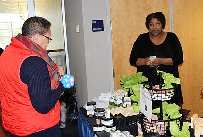 Kathy Reevie purchases shea butter from Monika Robinson (Mo Natural Beautiful’)