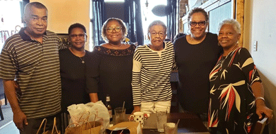 Kelly Carter, owner of Grind & Wine Restaurant located 3627 Offutt Road in Randallstown, Maryland in the middle of the shopping center and her friends.