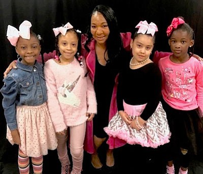 These  children  from God’s Little Angles Academy are the ambassadors for the event. They are posing with Kimberly Salley. founder of God’s Little Angels.