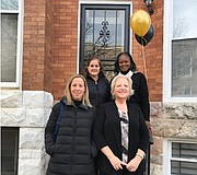 L-r: Amanda Owens, Abell Foundation; Ginny Robertson, President of the Light of Truth board of directors; (back row left to right) Elizabeth Perriello Rice, France Merrick Foundation; and  Betty Scott, Peer Housing Specialist LTC. They are standing  in front of the 933 W. Lafayette Avenue location.
