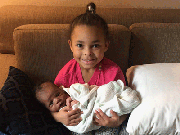 Nina holding her baby brother Gavi