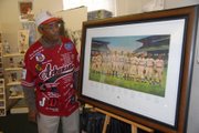 Ray Banks with a donated painting of Negro League baseball players