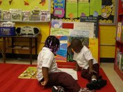 Two young students reading in the Ben Carson Reading Room at John Eager Howard Elementary School in Baltimore.                                 