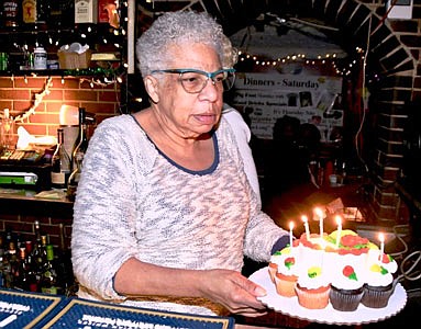 Veronica “Ronnie” Jackson, the owner of Roots Lounge for over 40 years and still going strong presents Birthday cake to “Rambling Rose.