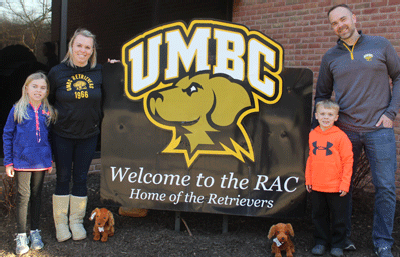 The Woelper family showed their support for their favorite basketball team by posing with UMBC mascot 