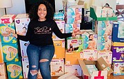 Sherise with boxes of Pampers at her home before the second Diaper Distribution event in May in Severn, Maryland.