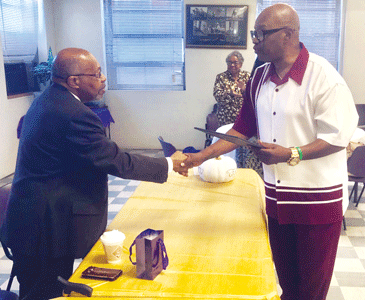 Rev. Daniel C. Worthy (left) being presented with his “Certificate of Achievement” for “Outstanding Service and Appreciation” by Pastor Norenzer White.