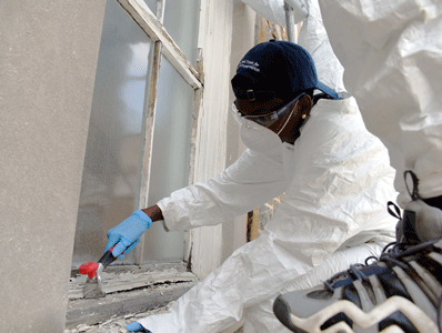 Zahaira Williams works on restoring a window at MSU’s Memorial Chapel