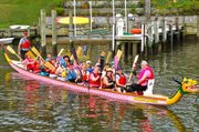 Twice a week club members— mostly women but some men— climb into two 44-foot long dragon boats and get a paddling workout along Spa Creek. 
