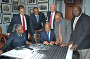 Rep. John Lewis (D-GA) reviews the schematic of the Civil Rights Foot Soldiers Memorial in his Washington office last Thursday with members of the organizing committee. The unveiling will take place on Wednesday in Annapolis. Pictured from left, Jacqueline Boone Allsup, President-Anne Arundel County Branch NAACP, Joshua J. Cohen, Mayor of Annapolis, Daryl D. Jones, Esq., Guarantor, US Rep. John Lewis, Marc L. Apter, PR Director for Foot Soldiers Memorial, Carl O. Snowden, Chairman Dr. Martin Luther King Jr. Committee, Inc. and Chief Joseph Johnson, Guarantor.  