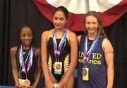 Nine-year-old Kennedy Stokes (left), won a medal for the 100 Breast at the annual AAU Junior Olympic Games that was held in Newport News, Virginia.