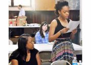 Kelly McNeely listens to her 16-year-old daughter, Jaida Griffin recite her original poetry at the “Black Words Matter” write-in, which was held on Sunday, May 3, 2015 in Baltimore.   