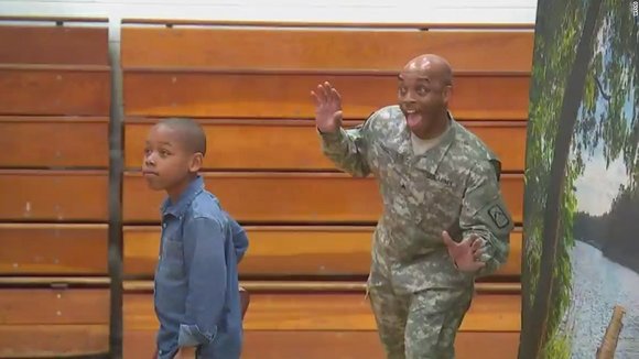 Soldier-dad surprises son by photobombing