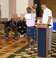 Walter Billups of NCIA (National Center on Institutions and Alternatives) presents Jeffrey Brandon with his graduate certification.