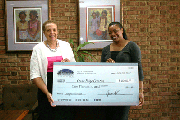  Joy Bramble, publisher of The Baltimore Times presents checks to grant winner, Cara Paige, founder, Color Paige Creative.