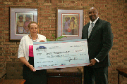 Joy Bramble, publisher of The Baltimore Times presents checks to grant winner, Anthony Shoats, CEO, Xquisite Transportation, LLC